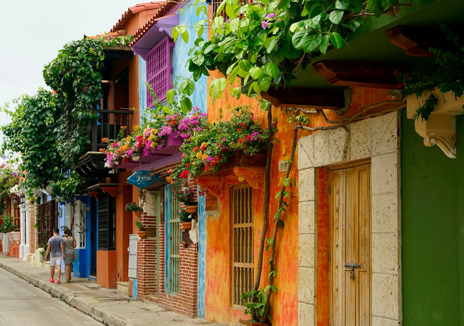 A flower-draped colonial street in the old walled city of Cartagena, Colombia