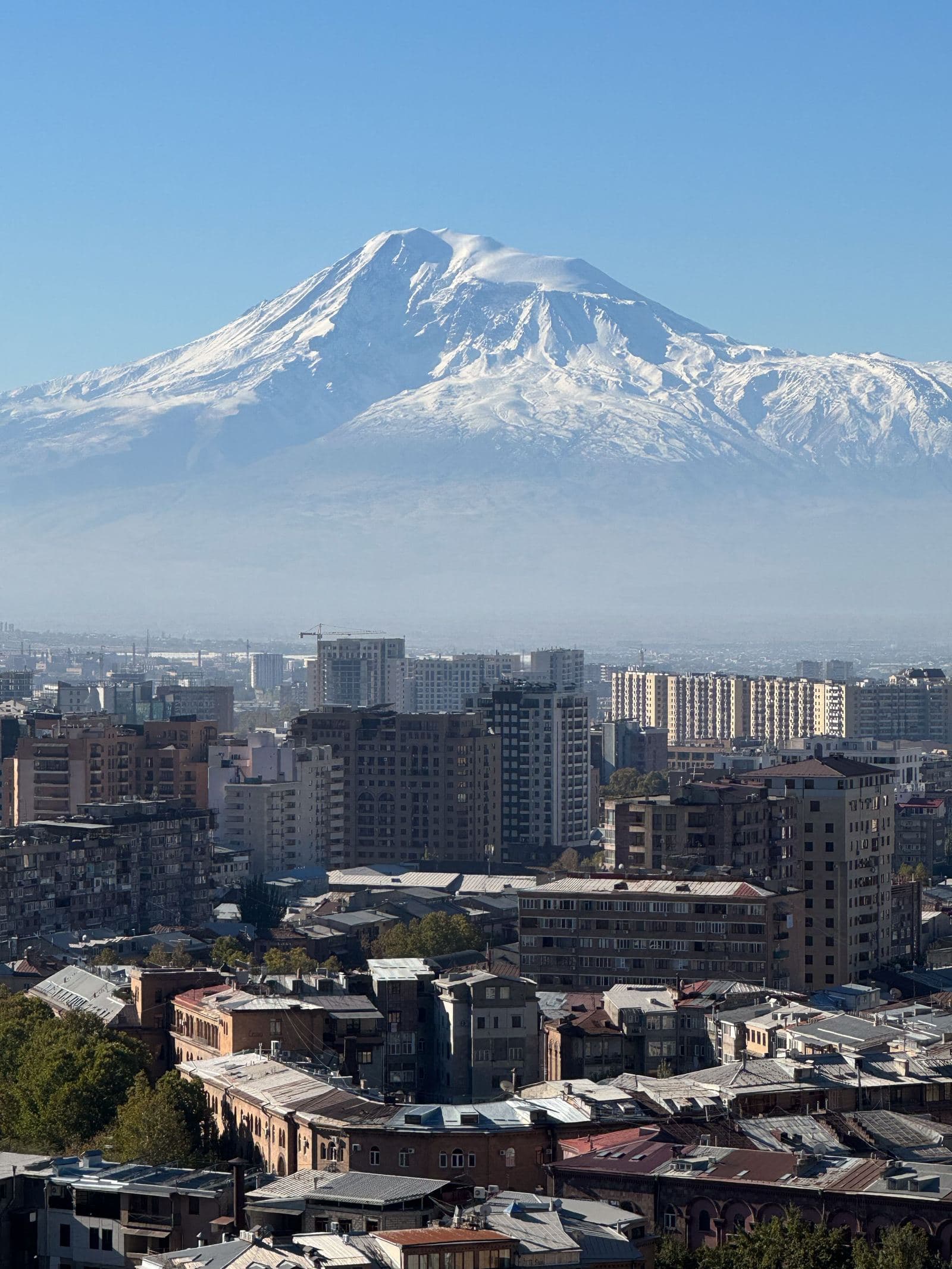 Snow-capped Mount Ararat rising behind the rooftops of Yerevan, Armenia