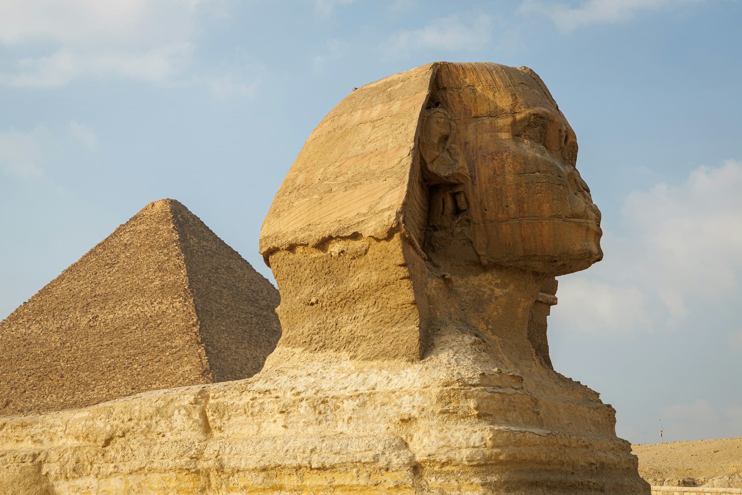 The Sphinx and the Pyramids of Giza, Egypt, under a clear desert sky