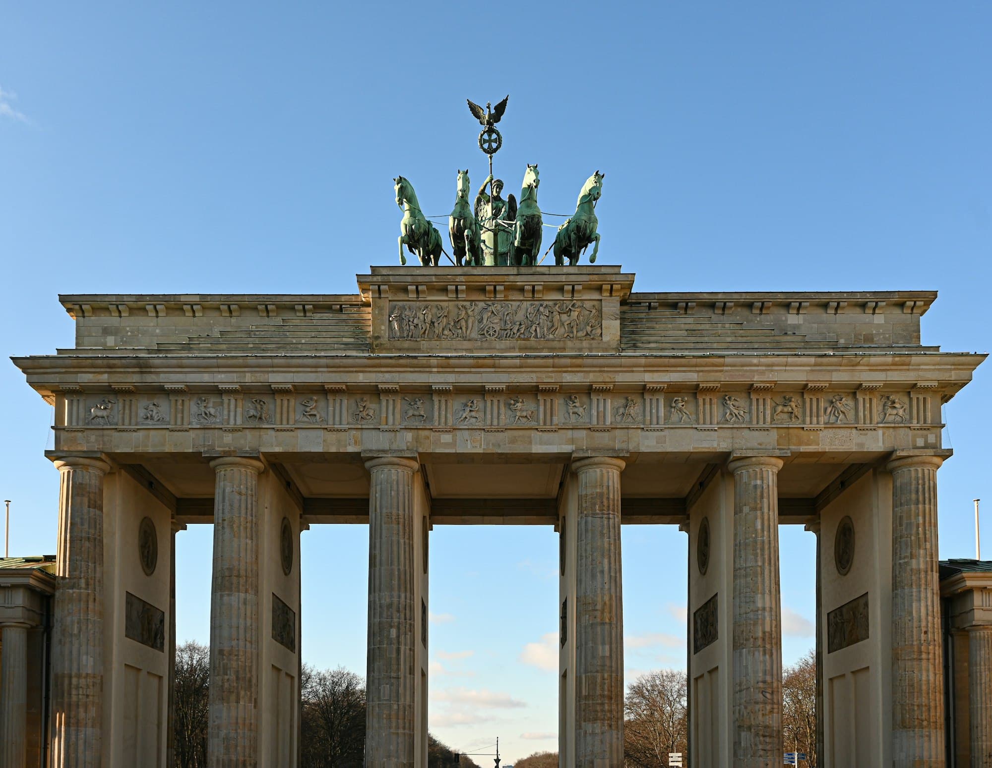 The Brandenburg Gate's Quadriga statue against a clear blue sky in Berlin, Germany